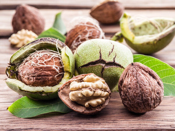 Walnut and walnut kernel on the wooden table.