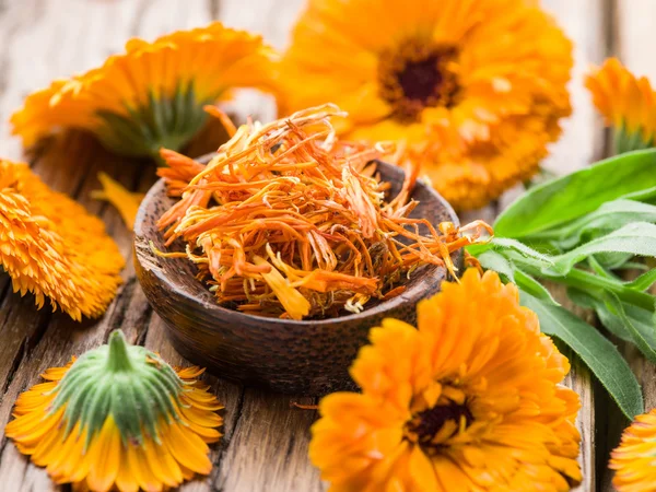 Calendula or marigold flowers on the old wooden table. — Stock Photo, Image