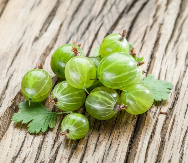 Gooseberries on the wooden table. — Stock Photo, Image