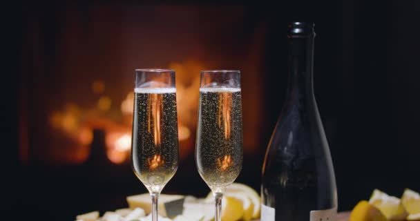 Bubbles Two Glasses Champagne Slowly Rise Upward Fire Fireplace Burning — Stock Video