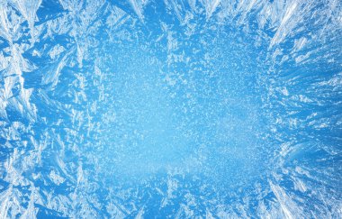 Frosty patterns on the edge of a frozen window. clipart
