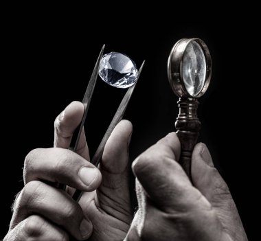 Kuyumcunun elindeki büyük değerli taş. Yaklaş. Gem tanımlama ve değerlendirme süreci.