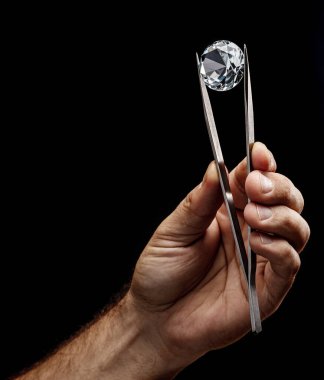 Kuyumcunun elindeki büyük değerli taş. Yaklaş. Gem tanımlama ve değerlendirme süreci.