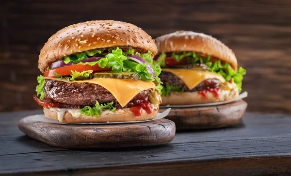 Delicious Two Hamburgers Wooden Table Dark Brown Background Fast Food — Stock Photo, Image