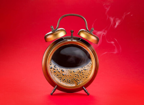 Steamy coffee drink collage. Hot coffee inside of a'larm clock as a symbol coffee time.