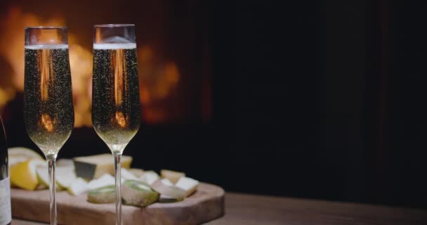 Bubbles Two Glasses Champagne Slowly Rise Upward Fire Fireplace Burning — Stock Video