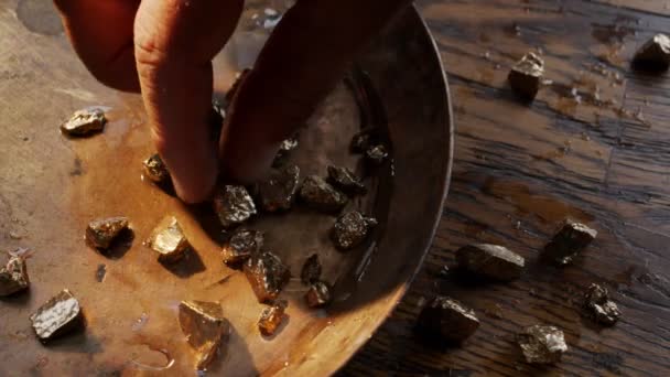 Mannelijke Handen Vingeren Verschillende Goudklompjes Een Kom Voor Het Wassen — Stockvideo