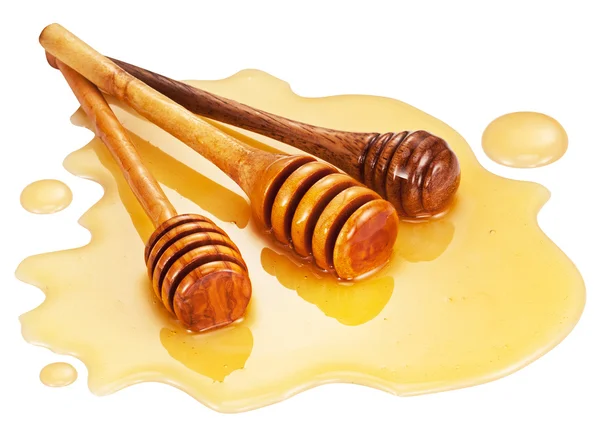 Wooden sticks in the honey puddle. — Stock Photo, Image