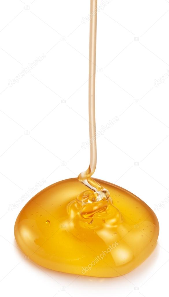 Honey flowing on white background.