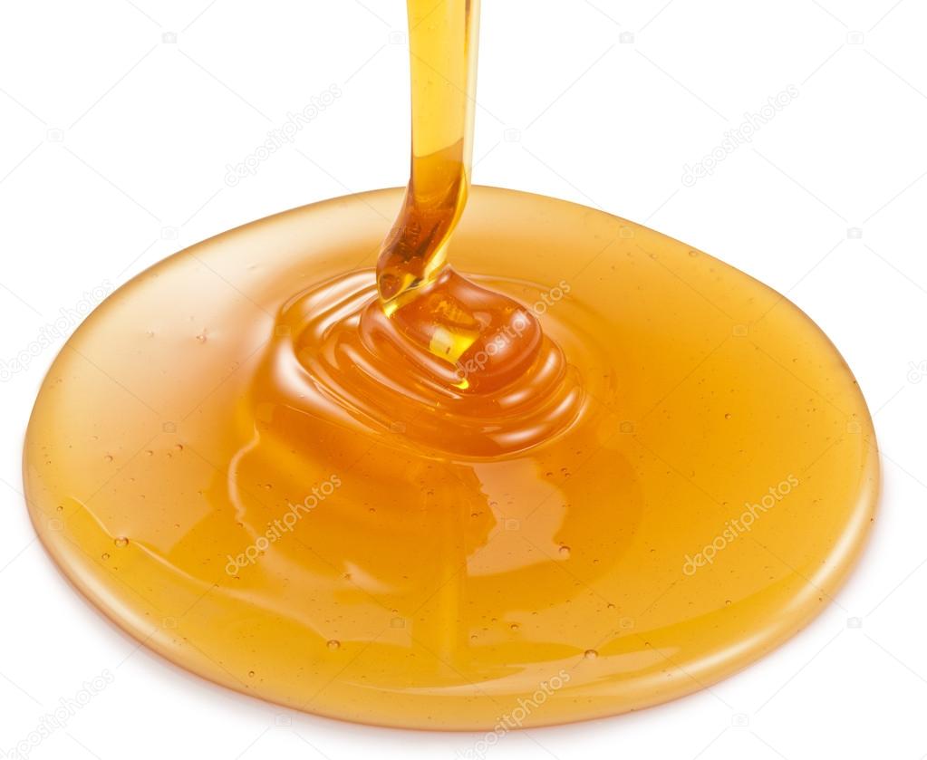 Honey flowing on white background. Clipping paths.