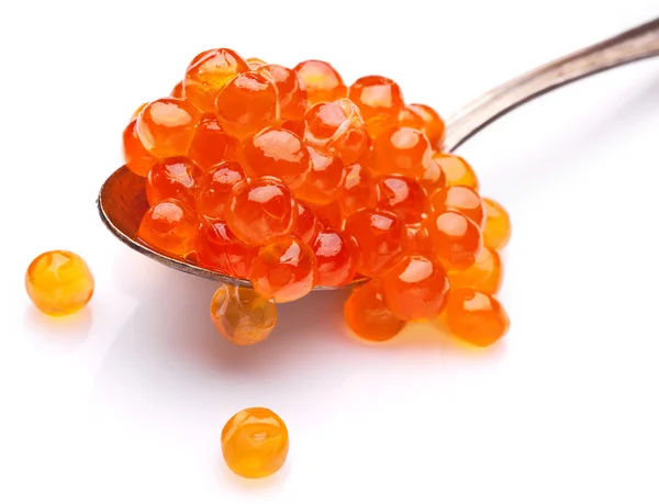 Red caviar in the silver spoon isolated on a white background. — Stock Photo, Image