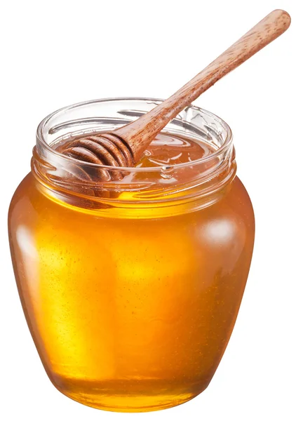 Glas kan full av honung och träpinne i den. Urklippsbanor. — Stockfoto