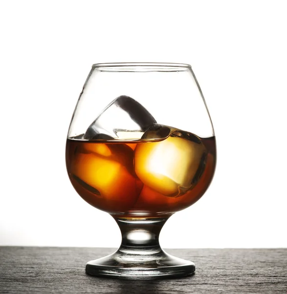 Glass of whiskey with ice on a white background. — Stock Photo, Image