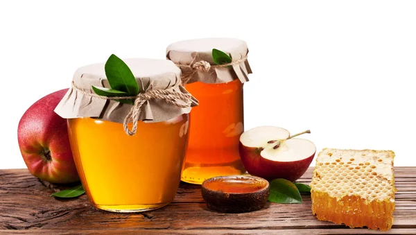 Glass cans full of honey, apples and honeycombs. Clipping paths. — Stock Photo, Image