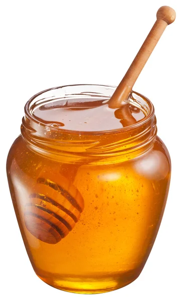 Glass can full of honey and wooden stick in it. Clipping paths. — Stock Photo, Image