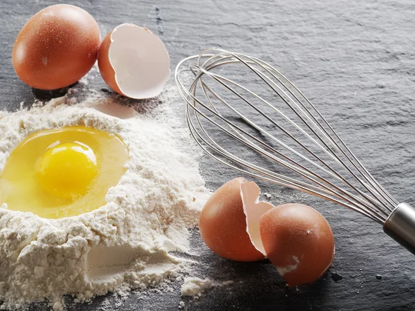 Dough preparation. Baking ingredients: egg and flour. — Stock Photo, Image