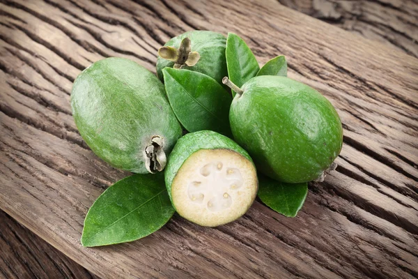 Feijoa fruits on old wooden table. — Stock Photo, Image