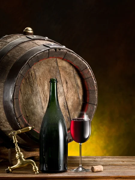 Still-life with glass of wine, bottle and barrel. — Stock Photo, Image