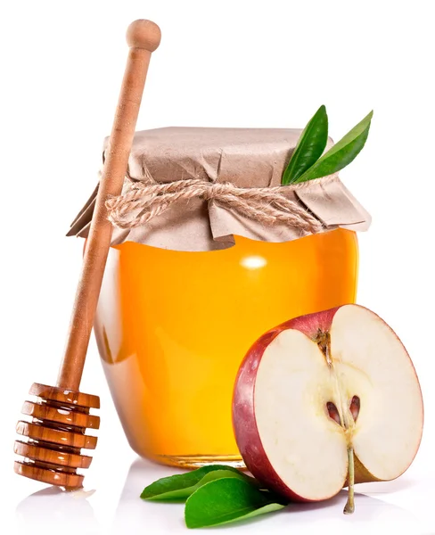 Glas kan vol honing, apple en houten stok. — Stockfoto