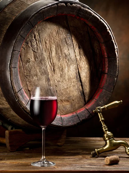 Still-life with glass of wine, bottle and barrel. — Stock Photo, Image