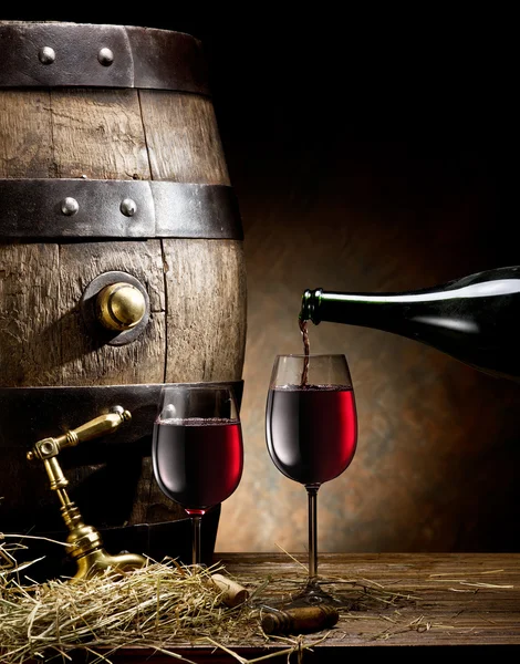 Still-life with glass of wine, bottle and barrel. — Stock Photo, Image