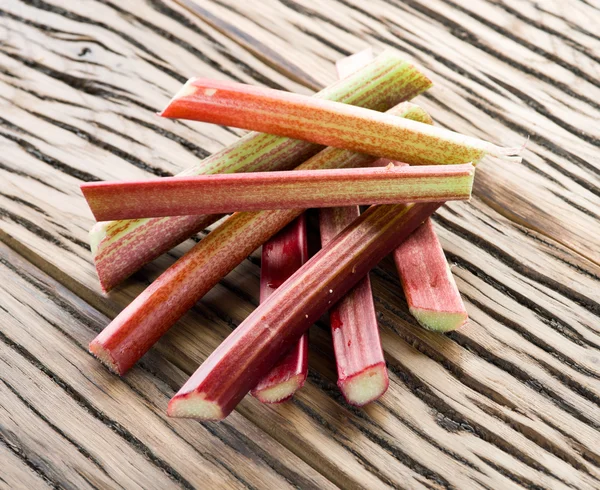 Rhubarb stalks on the wooden table. — Stock Photo, Image