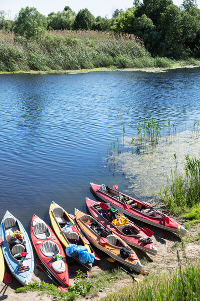 Canoes on a river-bank.