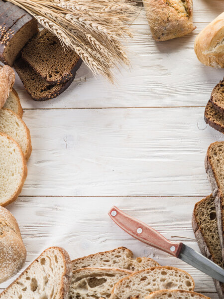 The bread and a wheat on the wooden desk.