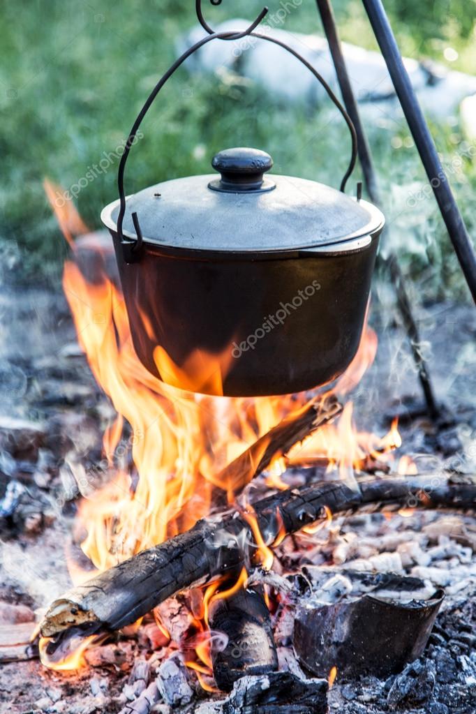 Cooking Large Pot Over The Fire Outdoors Stock Photo, Picture and Royalty  Free Image. Image 79928181.