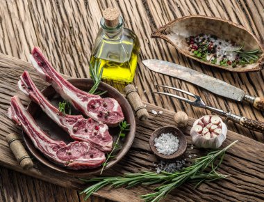 Raw lamb chops with garlic and herbs. clipart
