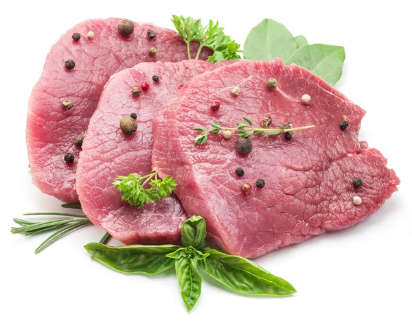 Raw beaf steaks with spices on a white background. — Stock Photo, Image