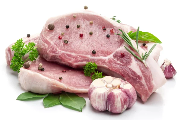 Raw pork meat steaks with spices on the white background. — Stock Photo, Image