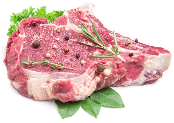 Raw beef meat steak with spices on the white background. — Stock Photo, Image