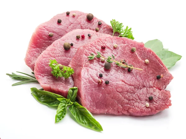 Raw beaf steaks with spices on a white background. — Stock Photo, Image