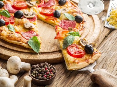 Mantar, salam ve domates pizza.