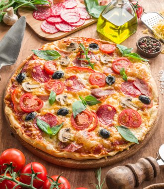 Mantar, salam ve domates pizza.
