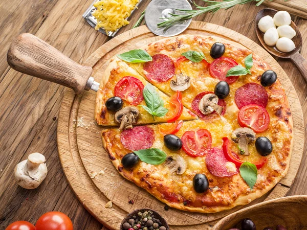 Mantar, salam ve domates pizza.