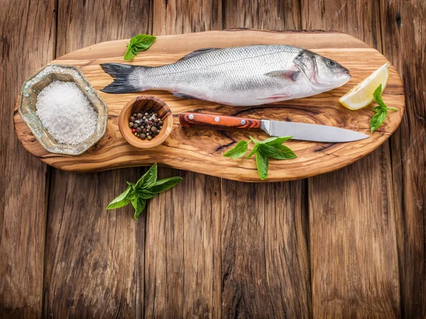 Seabass fish on the graphite board. — Stock Photo, Image