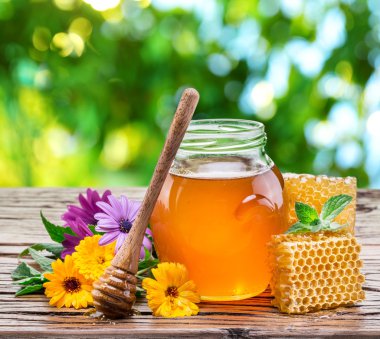 Jar full of fresh honey and honeycombs. High-quality picture. clipart