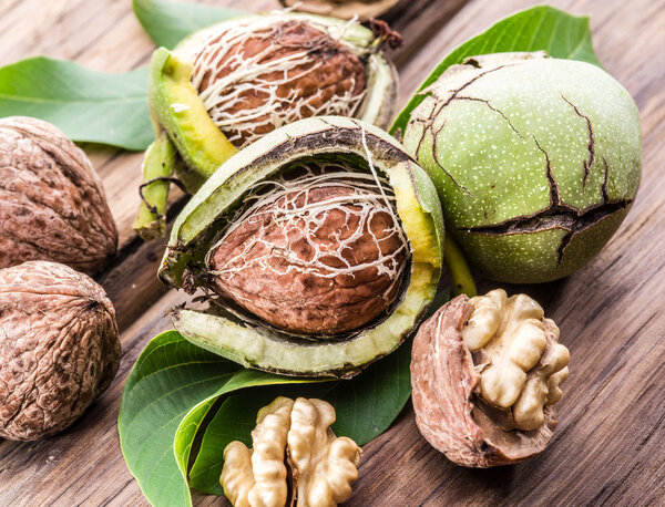 Walnut and walnut kernel on the wooden table.