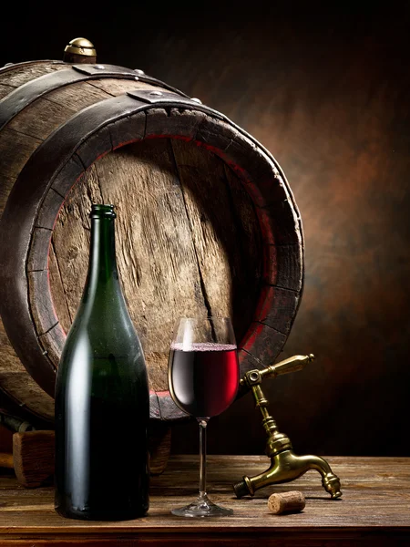 Still-life with glass of wine, bottle and barrel. — Stock Photo, Image