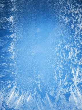 Frosty patterns on the edge of a frozen window. clipart