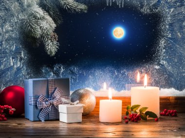 Christmas presents with burning candle on the windowsill with pa clipart