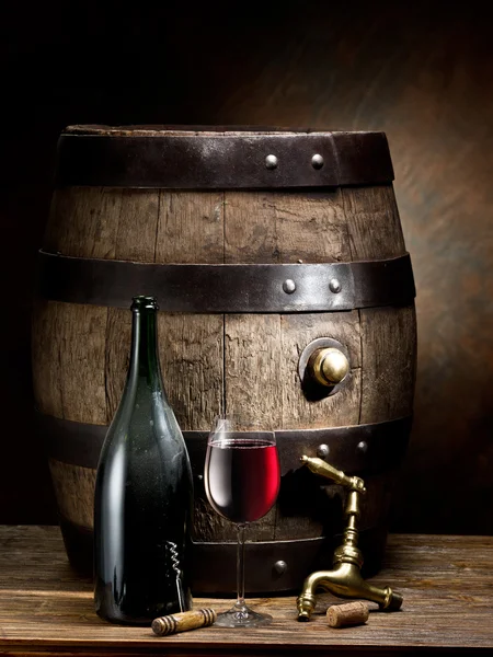 Still-life with glass of wine, bottle and barrel. — Stock Photo, Image