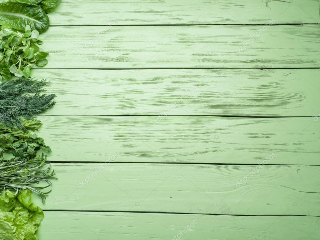 Green herbs on the green wooden background. Stock Photo by ©Valentyn_Volkov 92686602 Green herbs on the green wooden background. Stock Photo by ©Valentyn_Volkov 92686602