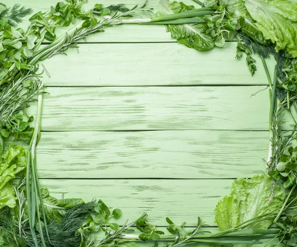 Green herbs on the green wooden background. — Stock Photo, Image