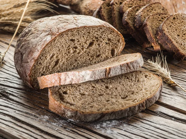 Zwart brood gesneden op de houten plank. — Stockfoto