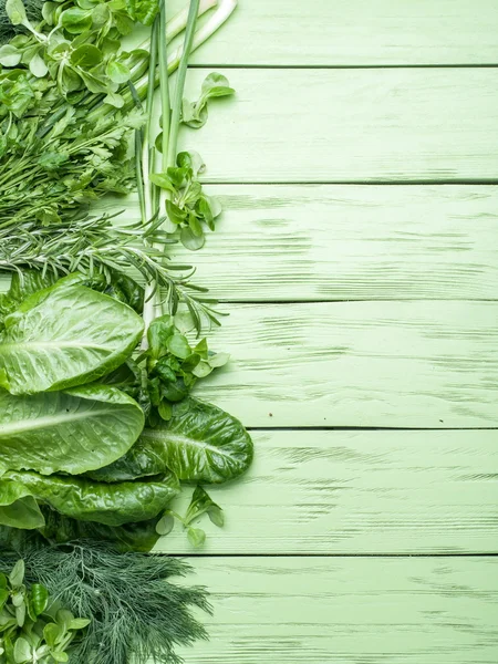 Green herbs on the green wooden background. — Stock Photo, Image