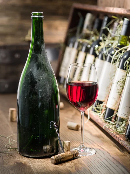 Wine bottles on the wooden shelf. — Stock Photo, Image