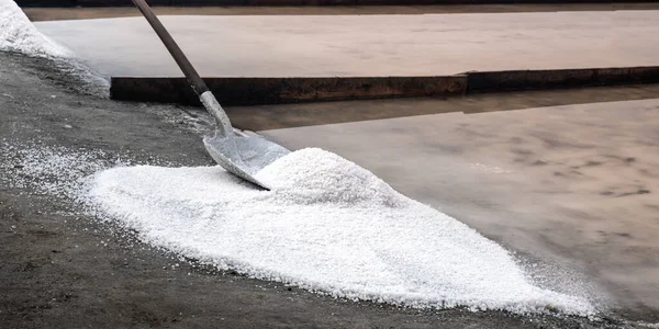 Different types of salt in salt pans with salt harvesting pools